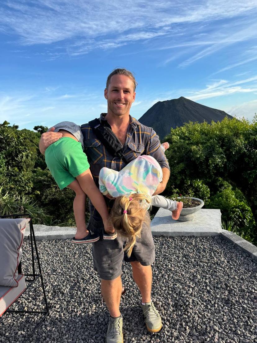 Jordan with his children in front of a volcano in El Salvador
